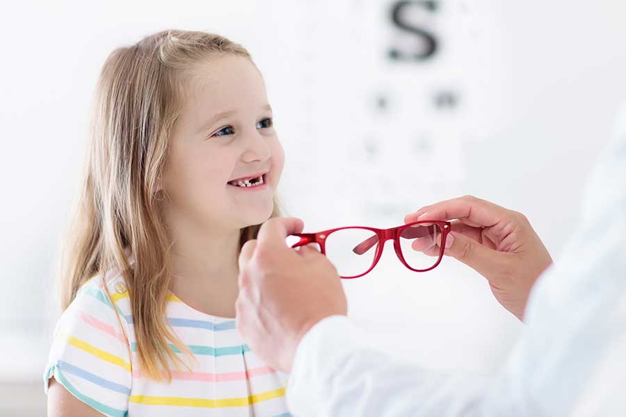Young girl getting fitted for eyeglasses
